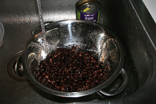 1. Open first can of black beans, rinse properly and drain