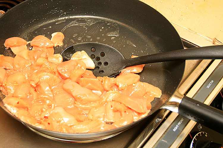 7. Heat up oil in a large pan slowly from medium to high heat. Add chicken and cook for about 5 minutes or until it is no longer pink. 